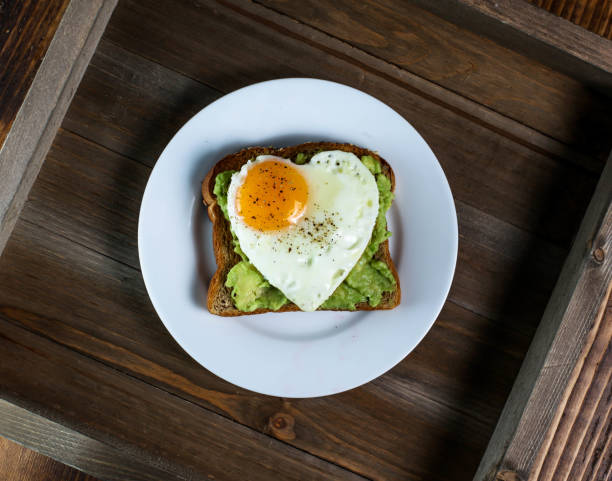 istock Toast with avocado and egg with heart shape 1046683516