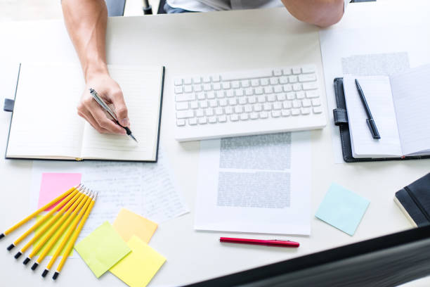 istock Businessman working writing business plan document and graphic designer with computer in office 1046693946