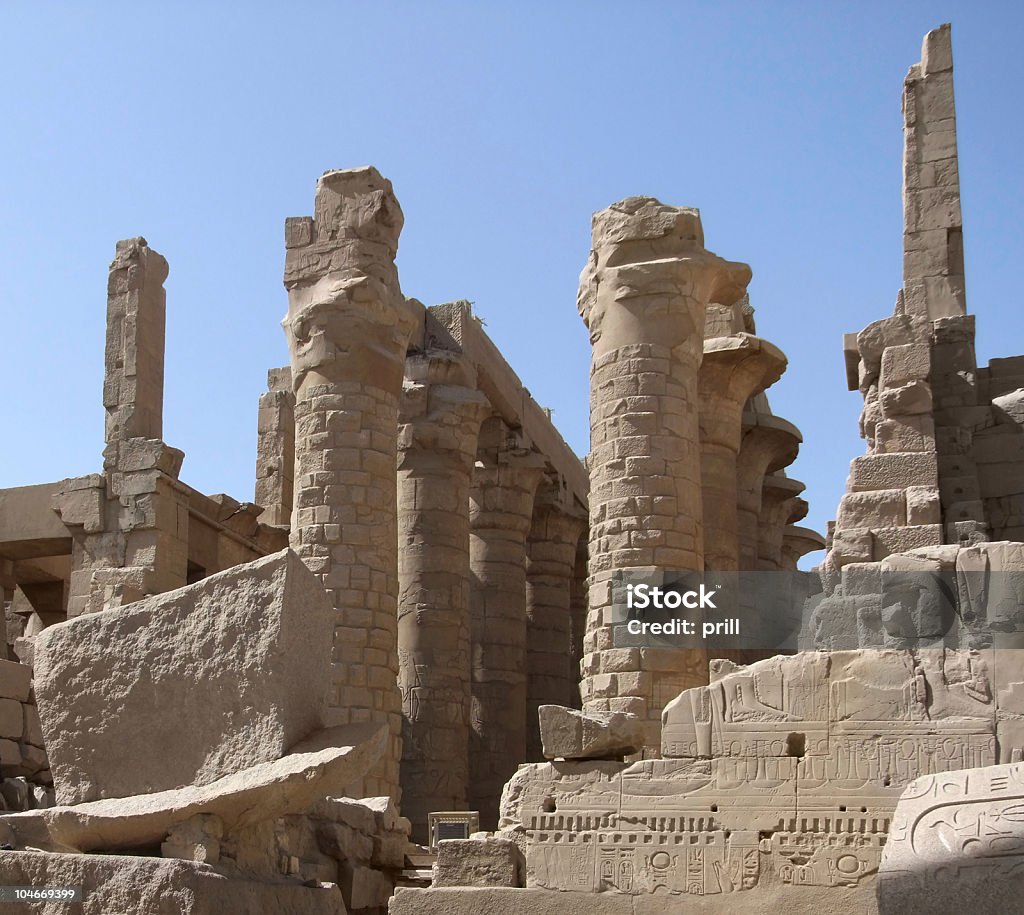stone remains around Precinct of Amun-Re sunny illuminated scenery around Precinct of Amun-Re in Egypt with various stone remains and columns in front of blue sky Africa Stock Photo