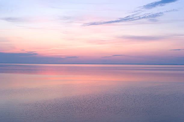 istock Soft pink and purple sunrise over calm waters 104670339