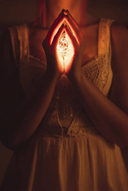 Young woman holding light in hands