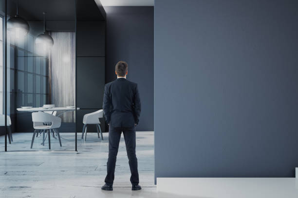 istock businessman in office with blank wall 1046714906