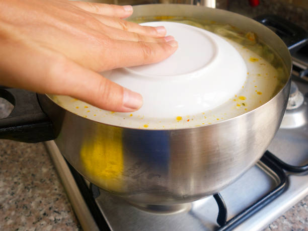istock Woman's hand in the cooking pot 1046715240