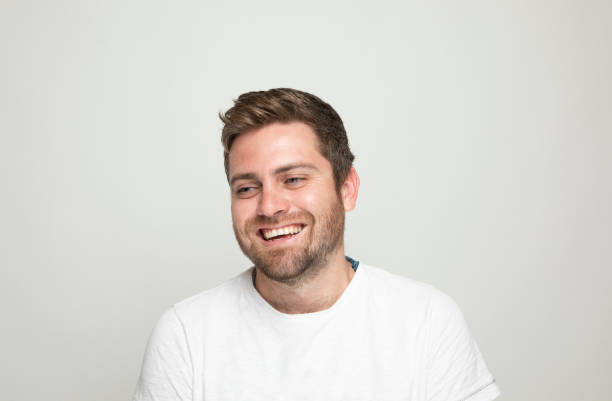 istock Laughing young man on gray background 1046725466