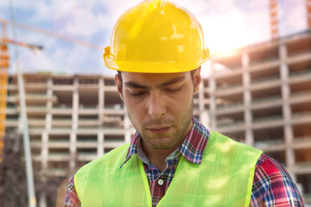 istock Young Engineer portrait with construction site and crane background. 1046725526