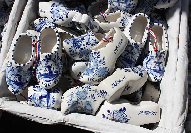 Souvenir from Holland ; a handmade and hand-painted miniature Dutch wooden shoe, isolated on white. Clog is 3.2 inches long.