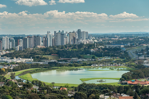 Lake of Parque Barigui viewed from above with Campo Comprido Neighborhood on the background. Residential area with multiplo high rises buildings.