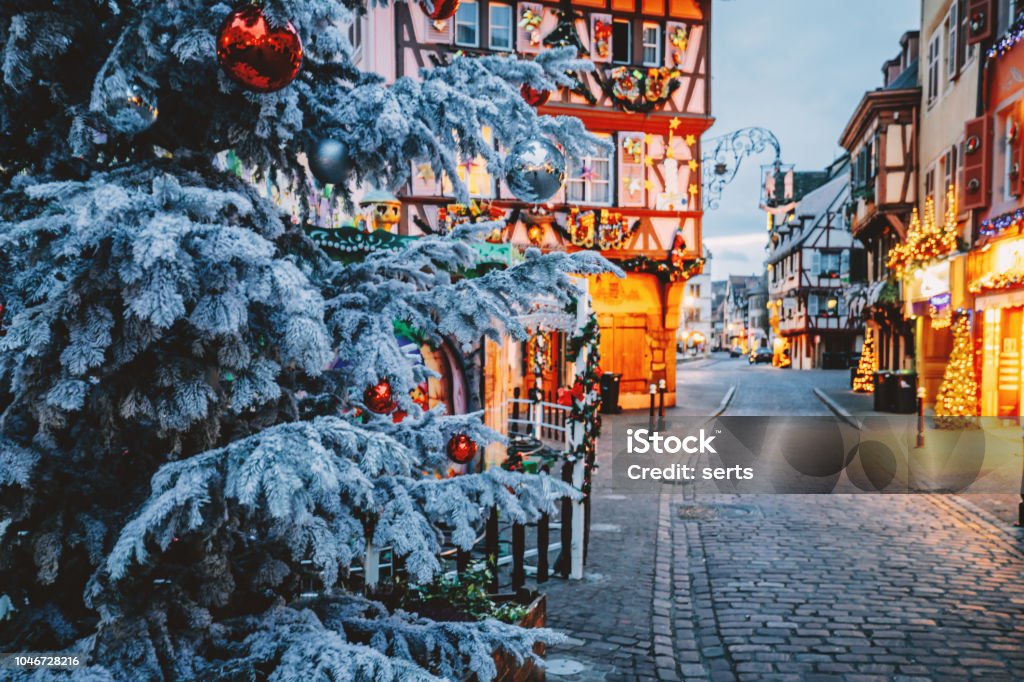 Christmas time in Colmar, Alsace, France Old town decorate magical like a fairy tale in Noel festive season with detail of Christmas tree with red ball ornates at early morning time in Colmar, Alsace, France. Christmas Stock Photo