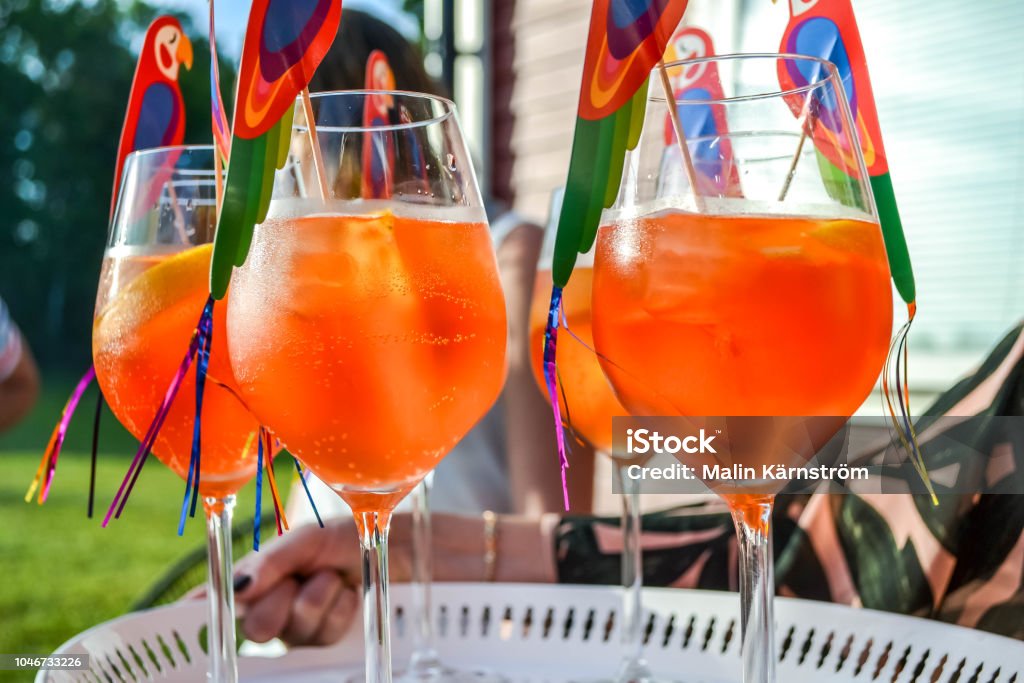 Aperol o'clock party Glass with Spritz on a tray Alcohol - Drink Stock Photo