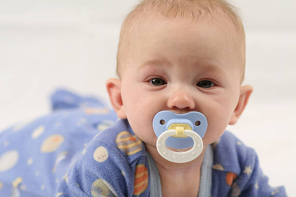 istock Crawling baby in blue with a blue pacifier 104673497