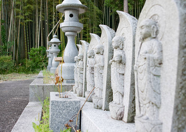 Statues of monks on a japanese graveyard stock photo