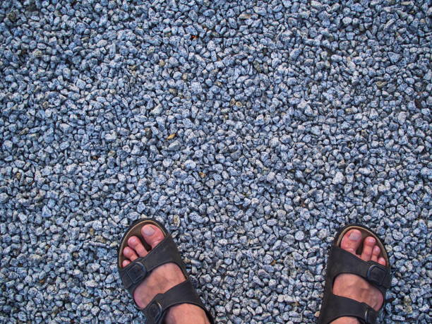 Feet of relaxed man enjoying the beach