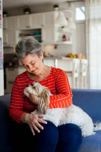 istock senior woman embracing her dog 1046764672