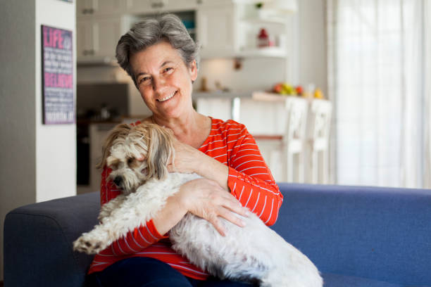 istock senior woman embracing her dog 1046764814