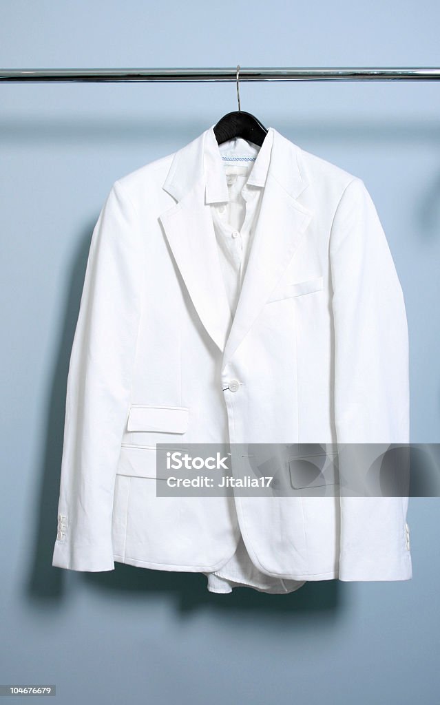 God's Closet - Solitary White Suit Hanging on a Rack  Bizarre Stock Photo