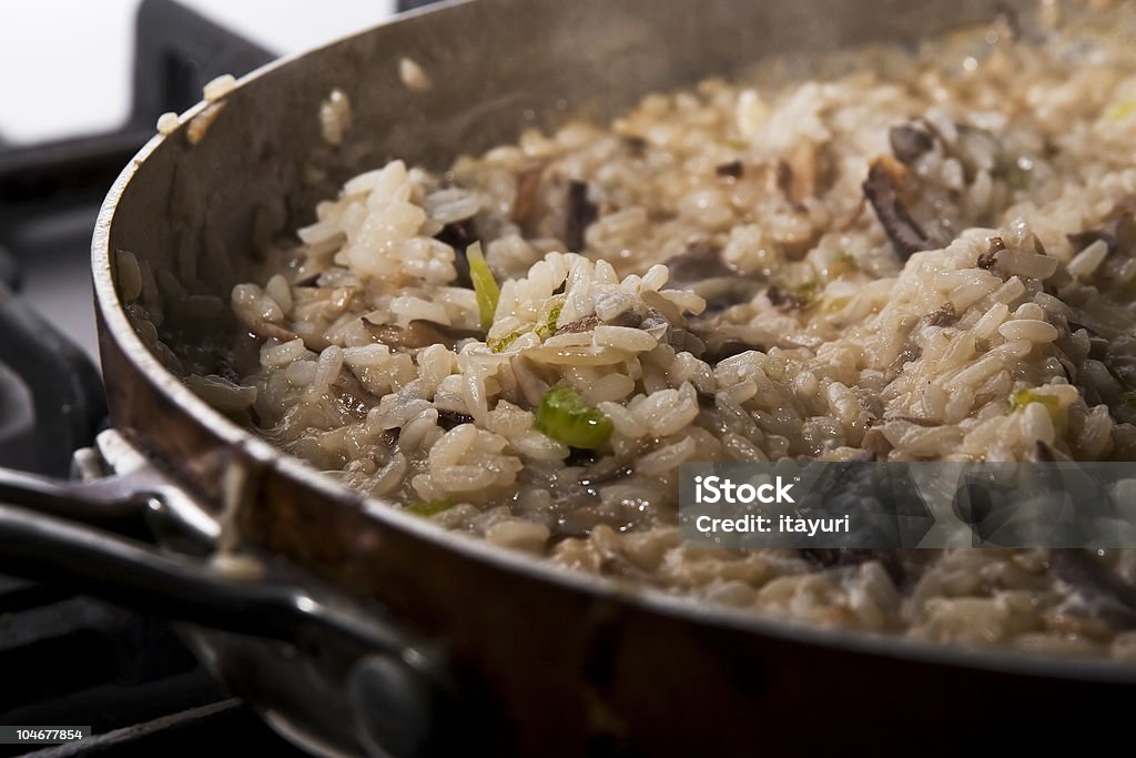 Close-up of mushroom risotto cooking on a stove closeup of pan with mushroom risotto Arborio Rice Stock Photo