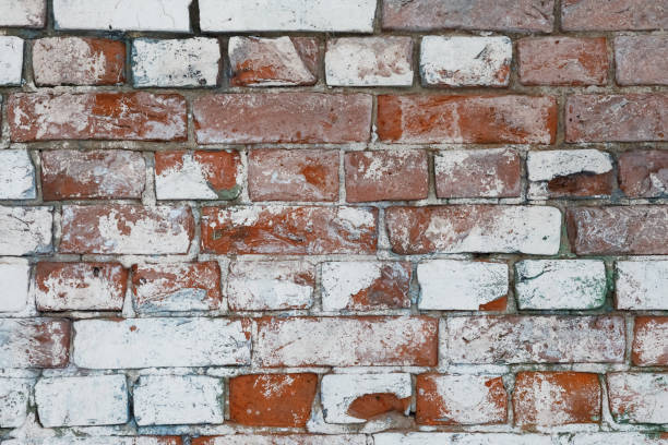 istock Red White Wall Background. Old Grungy Brick Wall Horizontal Texture. Brickwall Backdrop. Stonewall Wallpaper. Vintage Wall With Peeled Plaster. Retro Grunge Wall. With Uneven Stucco 1046779380