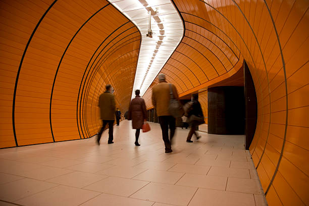 istock commuters against orange underground tunnel XL 104678688