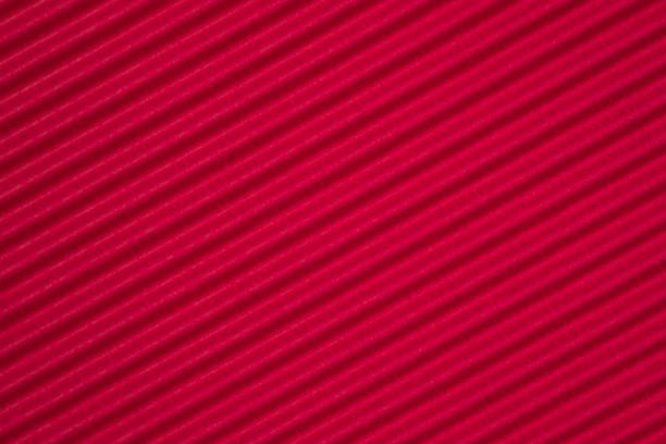 istock Red corrugated paper texture, use for background. vivid colour with empty space for add text or object. 1046787156