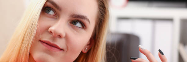 istock young pretty blond womansit on sofa hold smartphone in hands 1046787674