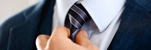 istock Male arm in blue suit set tie closeup 1046788070