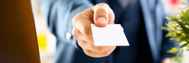 istock Male arm in suit give blank calling card 1046788074