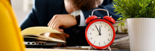 istock Red alarm clock shows late time closeup 1046788080