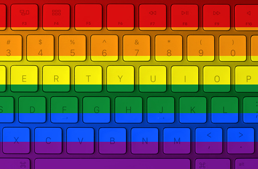 LGBT flag and computer keyboard in the background. Gay flag