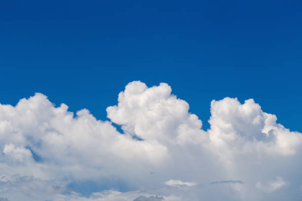 istock White fluffy clouds in the blue sky background 1046798244