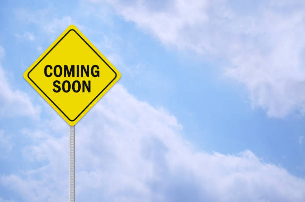 coming soon written on traffic sign stock photo