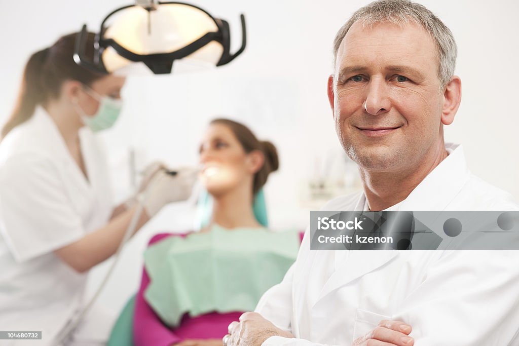 Dentist in his surgery  Adult Stock Photo