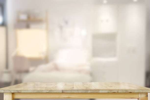 istock Empty wooden table over living room background. 1046808030