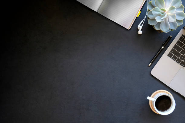 istock Office dark leather desk laptop and supplies. Workspace and copy space 1046808152