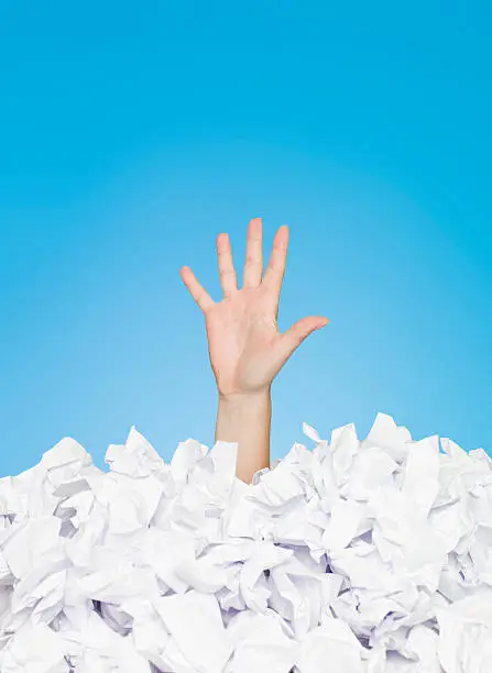 Human Buried in white papers on blue background