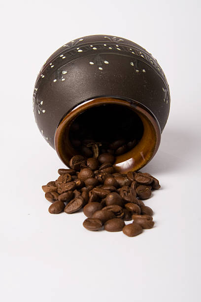 Clay pot with coffee beans stock photo