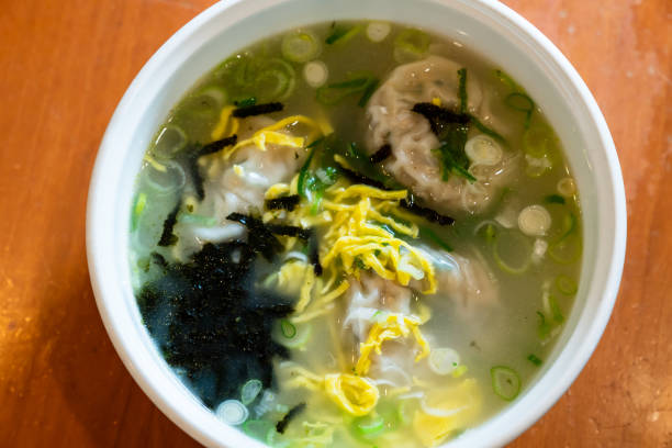 istock Korean dumpling soup with garnish such as fried eggs, Welsh onion, dried laver. 1046829484