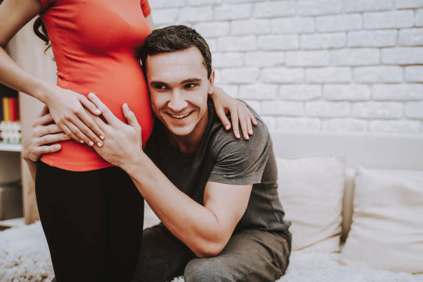 istock Love Each Other. Pressed Ear to Belly. Happy. 1046833120