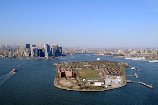 Domino Park along the East River in Williamsburg Brooklyn during spring with trees and a Manhattan skyline view in New York City