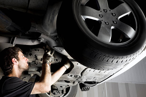 istock Auto mechanic working under the car 104685798