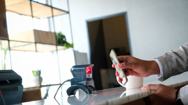 istock Man making contactless payment with smartphone 1046859586