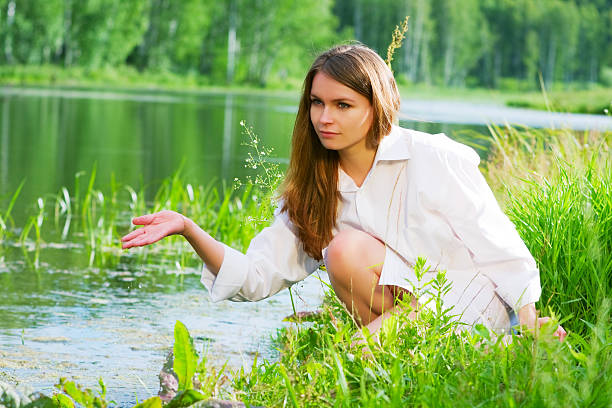 Girl in an embroidered dress on the lake