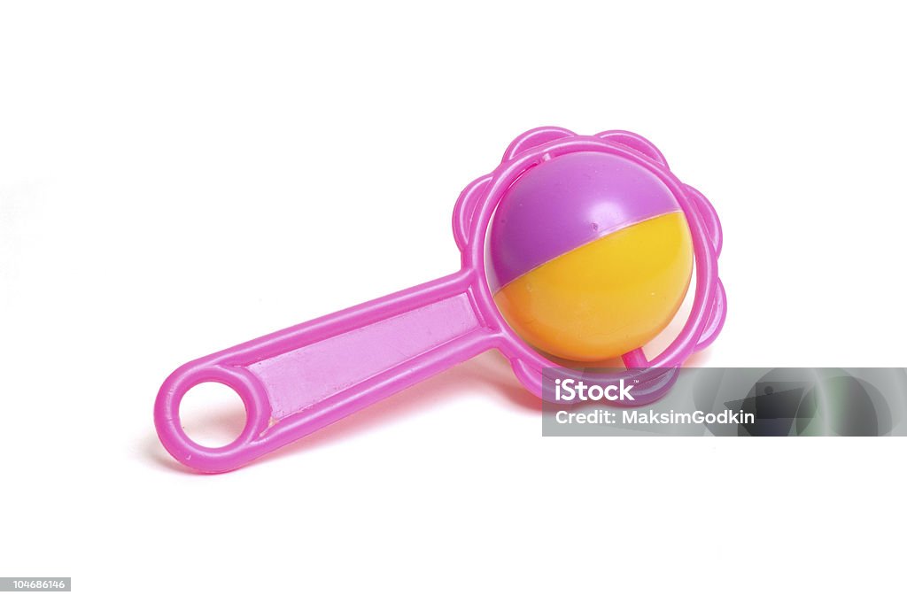 A pink and yellow toy on a white background the toy rattle Toy Rattle Stock Photo