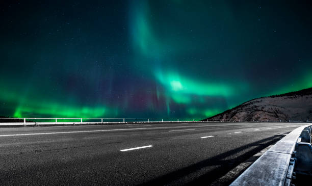 istock aurora borealis over asphalt road in Canada 1046867394