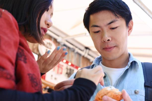 istock Young travellers exploring a fish market 1046869322