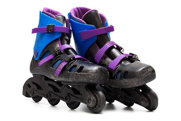 istock Very worn black roller skates with blue and purple accents 104687012