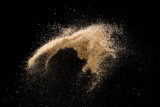 istock Sand flying explosion isolated on black background ,throwing freeze stop motion object design 1046872384