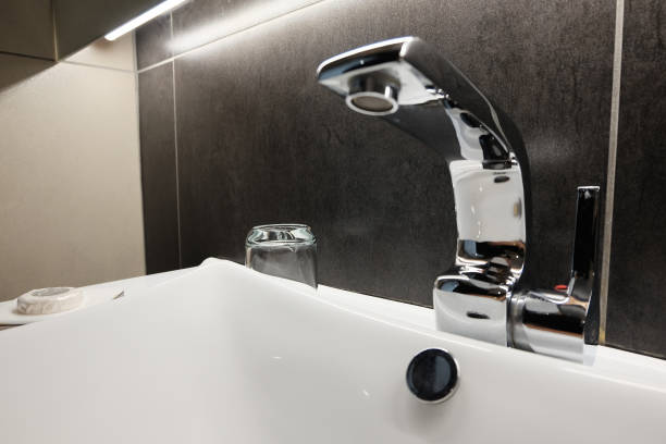 istock chrome water tab and seramic sink bowl in bathroom. selective focus and color tone effect 1046875412