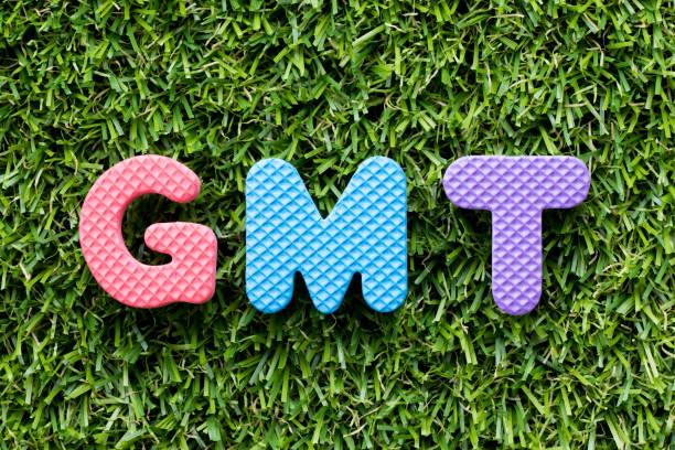 istock Color alphabet letter in word GMT (abbreviation of Greenwich Mean Time) on artificial green grass background 1046888902