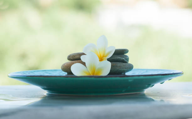 istock spa objects and stones for massage treatment in plate on marble background. 1046889070
