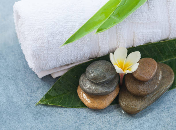 istock spa tropical flower with stones for massage room 1046889188